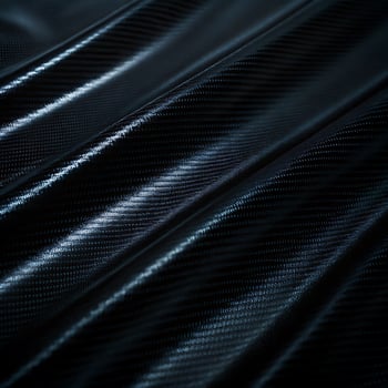 Closeup of a dark, glossy carbon fiber texture. photo