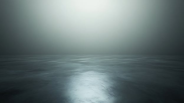 Abstract shot of a smooth, slightly reflective surface under soft lighting. Space is undefined creating a sense of mystery and tranquility. photo