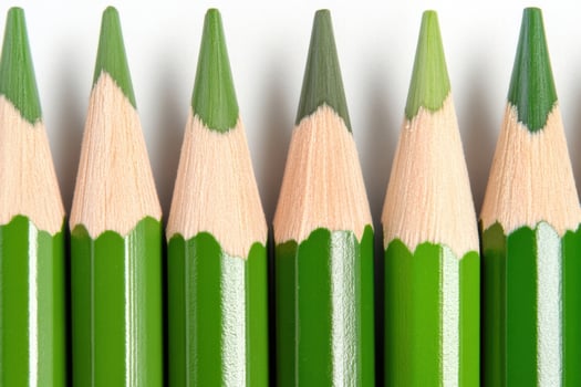 Collection of green pencils arranged in a straight line showcasing sharp tips and smooth wooden texture for creative projects and artistic expressions photo
