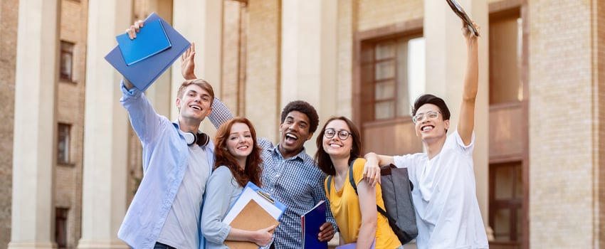 Portrait of excited international high school students raising hands up in the air after passing exam successfully photo