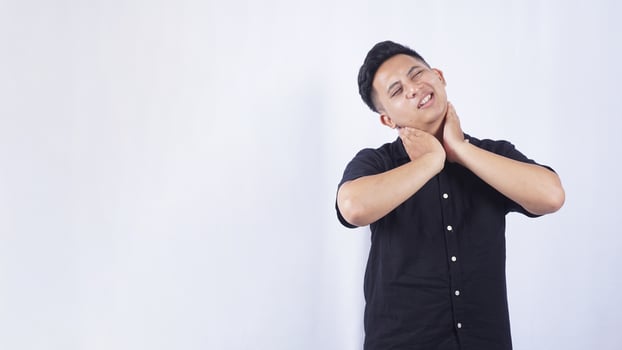 Asian Man Suffering from Pain in The Neck on White Background photo