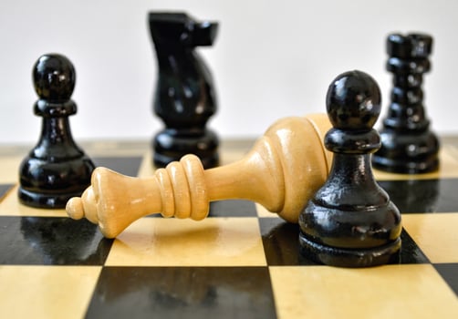 The black pawn defeated white queen on chessboard photo