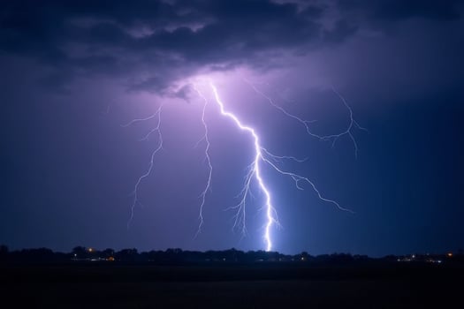 Dramatic Nighttime Lightning Strike Over Dark Rural Landscape photo
