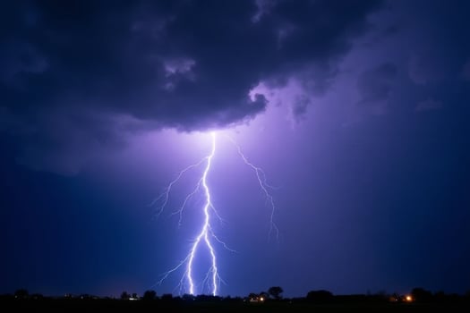 lightning strikes over a dark sky with a large cloud in the background photo