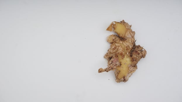 Top View of Peeled Ginger Spice on White Background photo