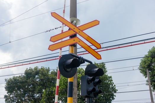 Railroad crossing sign with loudspeaker and signal lights photo