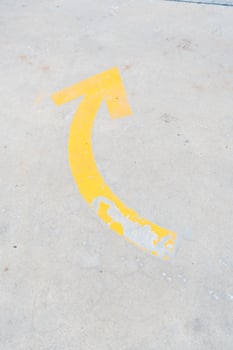 Road surface with thick yellow arrow indicating ahead direction. photo