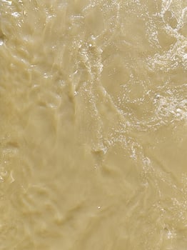 Muddy River Current Creating Organic Foam Textures photo