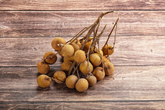 A bunch of fruit on a wooden table photo