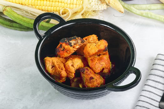 A bowl of food with some vegetables and a knife photo