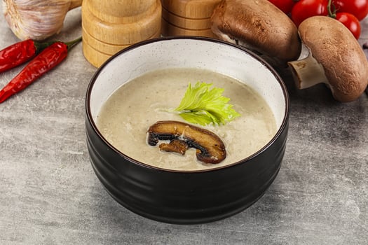 A bowl of soup with mushrooms and vegetables photo