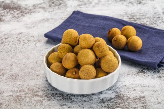 A bowl of kiwis on a table photo