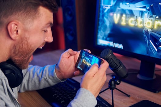 A man is playing a game on his phone photo