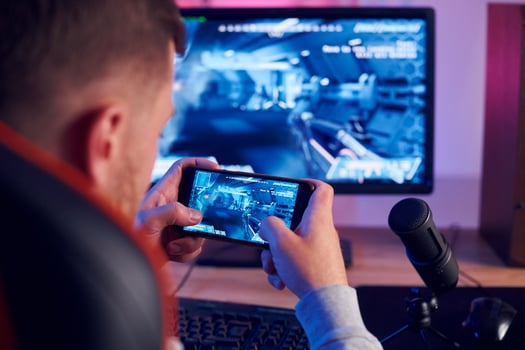 A man is playing a game on his phone photo
