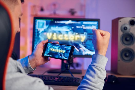 A man is playing a game on his phone photo