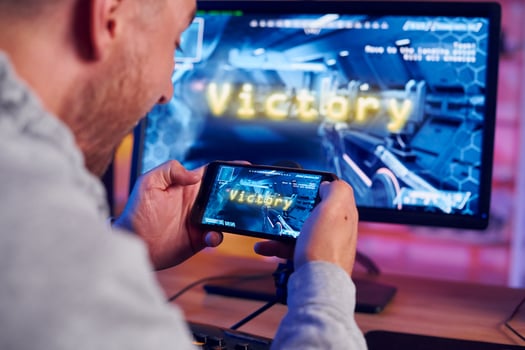 A man is playing a game on his phone photo