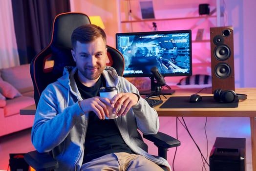 A man sitting in a chair with a cup of coffee photo