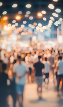 Blurred bustling street scene with pedestrians and vibrant lights creates a bokeh effect photo