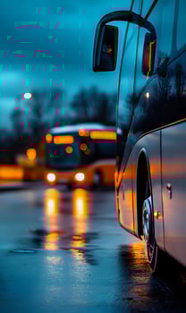 City transport on a rainy evening reflecting the vibrant lights of the bus headlights photo