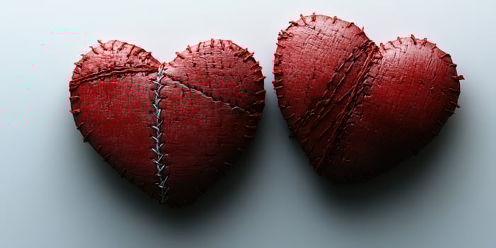 Creative red stitched hearts symbolizing love and connection on a neutral background in soft lighting photo