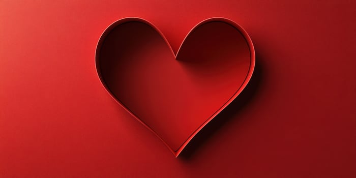 Heart shape crafted with red paper displayed against a solid red background to symbolize love and affection photo