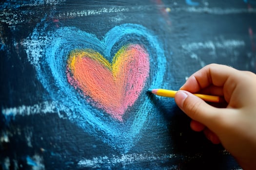 Hand drawing colorful heart on blackboard photo
