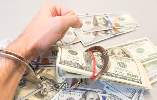 Handcuffed Person Counting Cash - Fraud, Crime, and Financial Investigation Concept photo