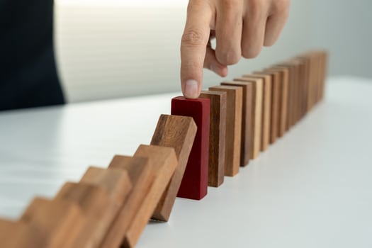 hands protect domino. Businessman hands stop dominoes falling in business crisis. business risk control and planning and strategies to run prevent insurance businesses photo