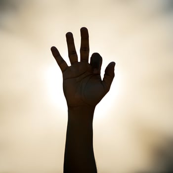Outstretched hand reaching towards warm sunlight with bokeh effect symbolizing hope new beginnings photo