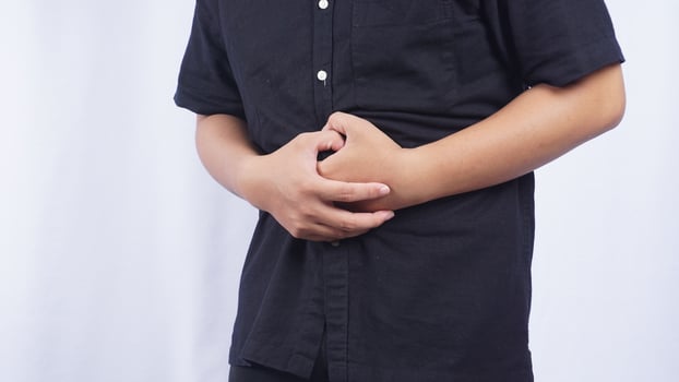 Close Up of Man with Stomach Pain on White Background photo