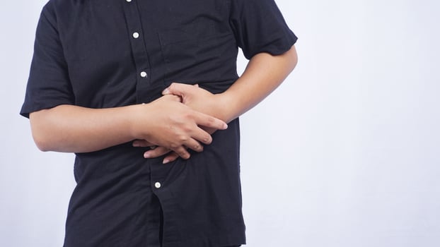 Close Up of Man Having Stomach Pain on White Background photo
