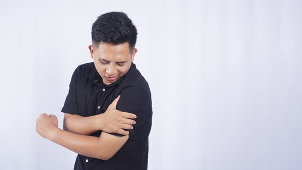 Asian Man with Stiff Muscle on White Background photo
