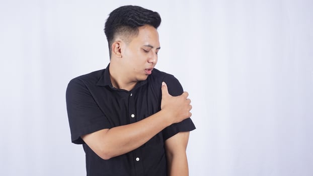 Asian Man with Stiff Shoulder on White Background photo