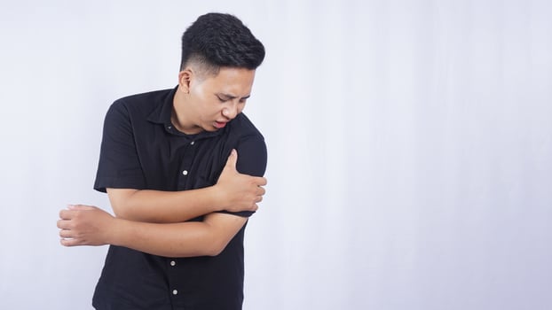 Asian Man Suffering from Stiff Muscle on White Background photo