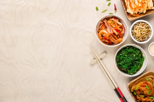 Asian korean food and chopsticks on wooden background photo
