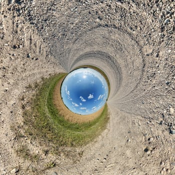 A view of a blue sky from inside a hole photo
