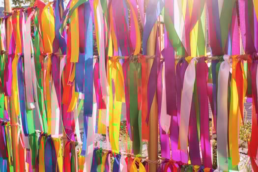 Colorful ribbons hanging vertically, creating a festive and celebratory atmosphere. Variety of colors, textures, and patterns, symbolizing diversity and joy. photo