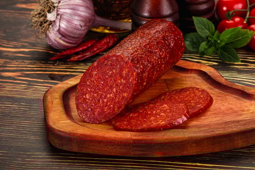 A wooden cutting board with a piece of meat on it photo