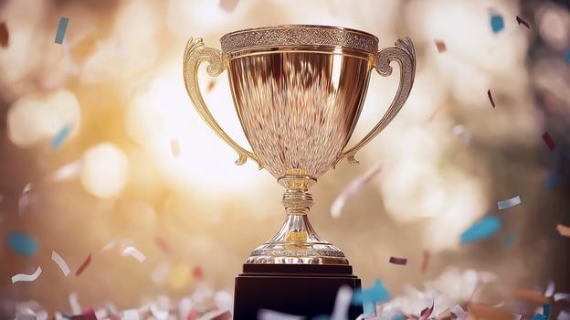 achievement of result, achieving the best result, isolated abstract golden cup on blurred background surrounded by falling tinsel photo