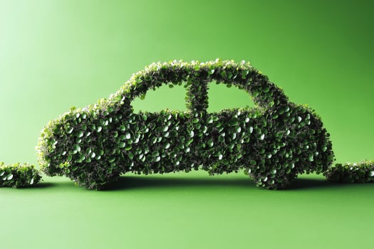 eco friendly transport concept, abstract image of eco friendly car green grass laid out in the background of the car on a plain green background photo