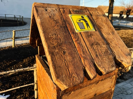 Rustic Wooden Trash Bin with Sign in Outdoor Park Environment photo