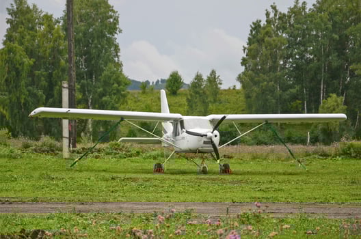 A small white plane stands on the ground, small aviation photo