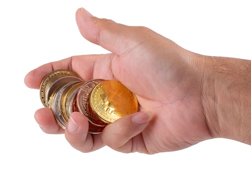 man hand holding golden Bitcoin isolated on a white background photo
