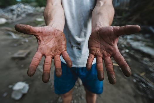 Dirty hands reaching out, a symbol of hard work photo