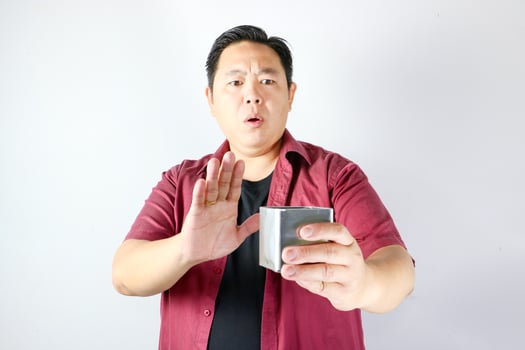 A man holding a stainless steel box and showing refusal sign, saying no and rejection gesture photo