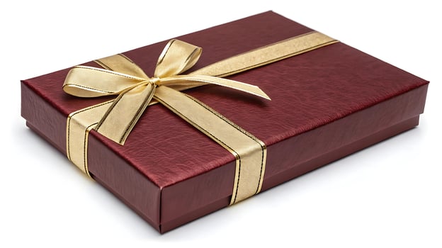 Maroon gift box with golden ribbon bow, elegant textured design photo