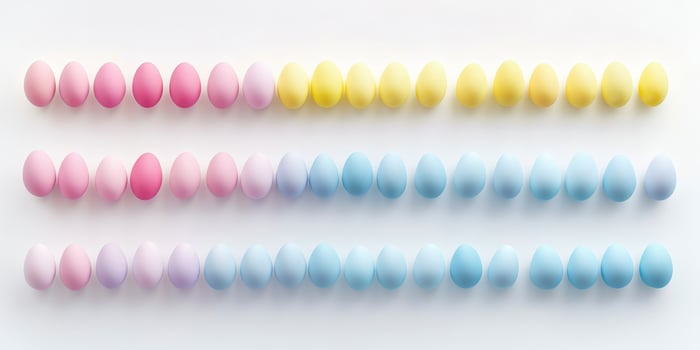 Rows of colorful pastel easter eggs arranged neatly on white background photo