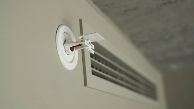 Fire sprinkler on the wall with vacuum sealed glass tube. photo