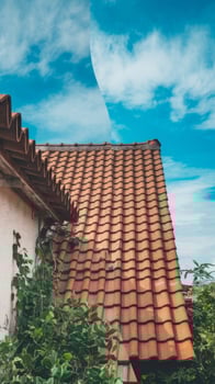 A house with a tiled roof and a blue sky photo