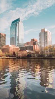 A city skyline is reflected in the water photo